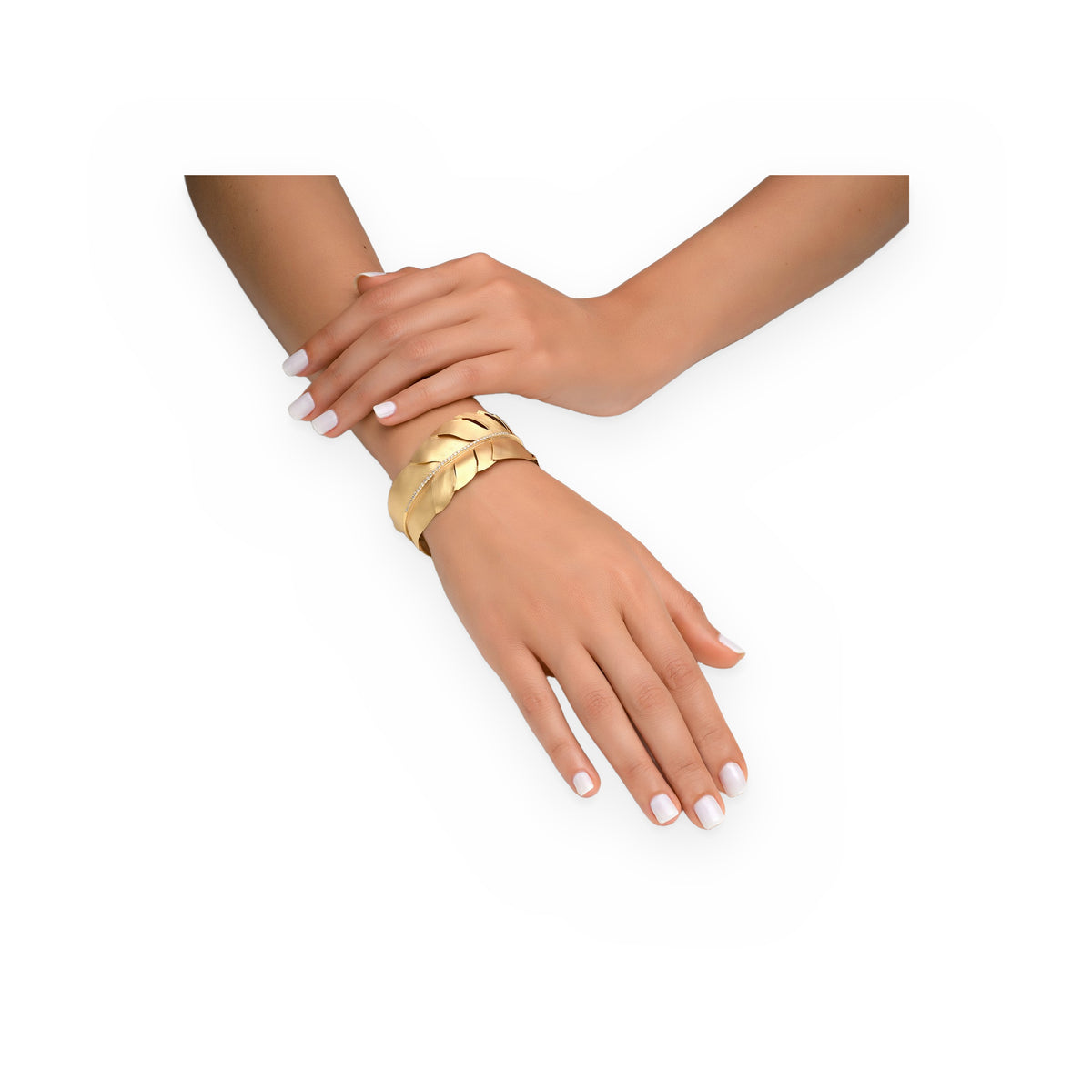 Yellow gold feather cuff bracelet worn on a model's wrist