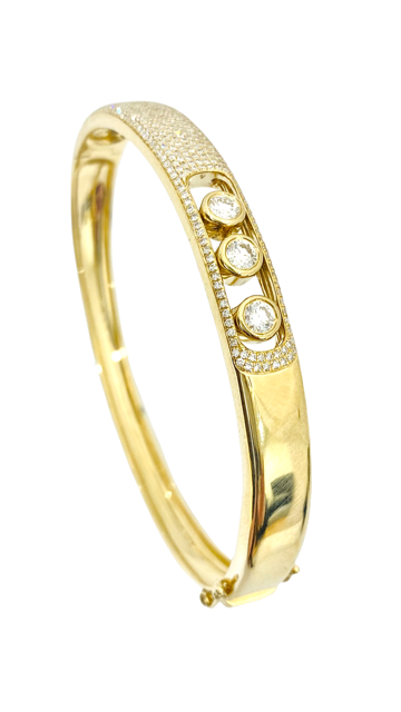 Yellow gold pave diamond bangle with sliding stones, angled view