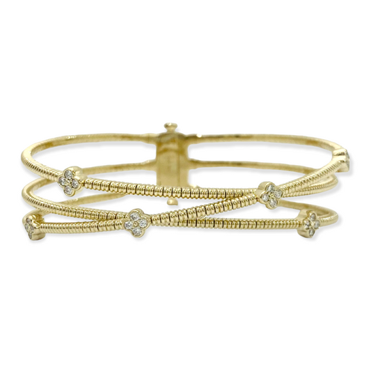 Yellow gold crossover bangle with diamond quatrefoil stations