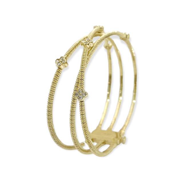 Yellow gold crossover diamond clover bangle, angled view