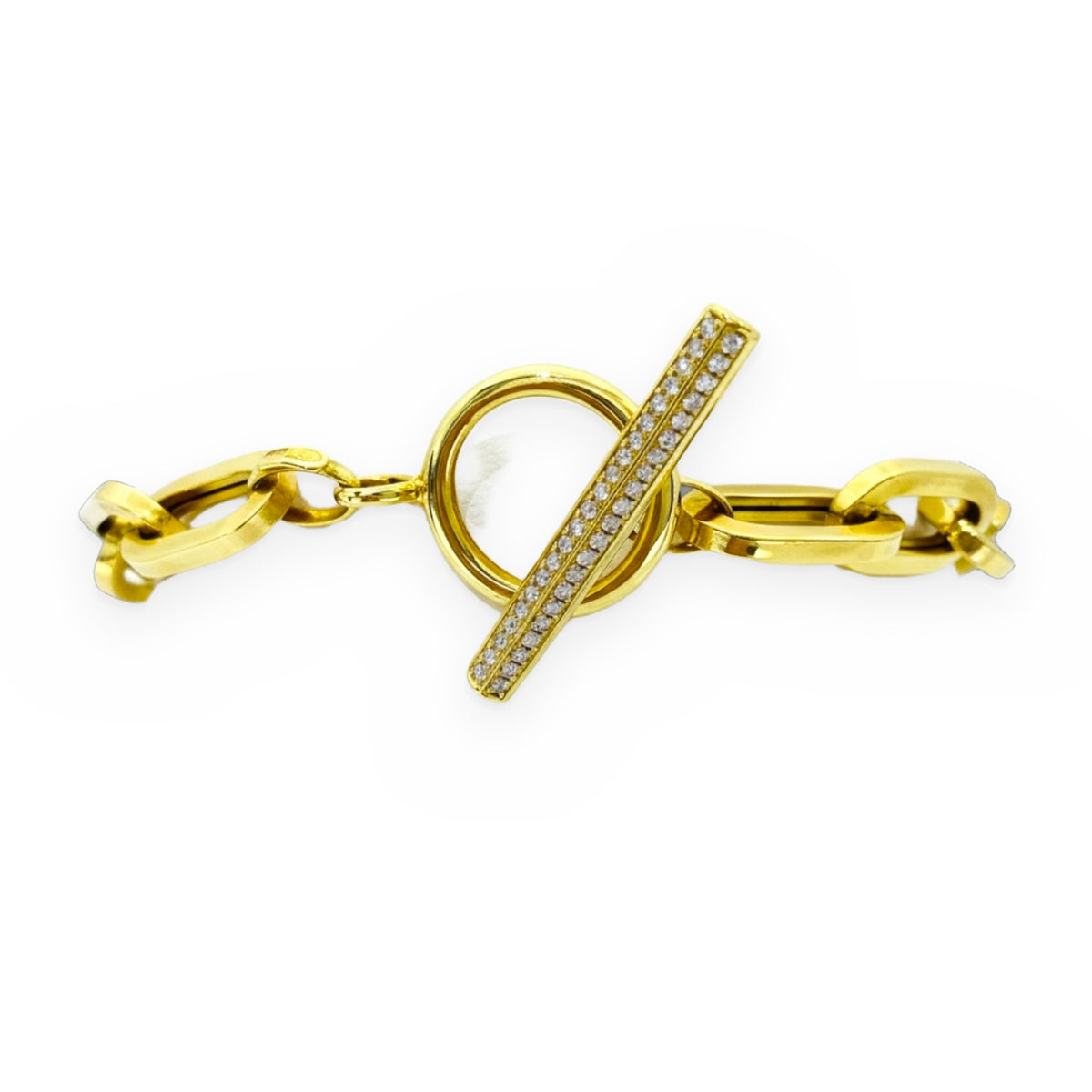 Yellow gold link bracelet with diamond toggle clasp on a display pillow