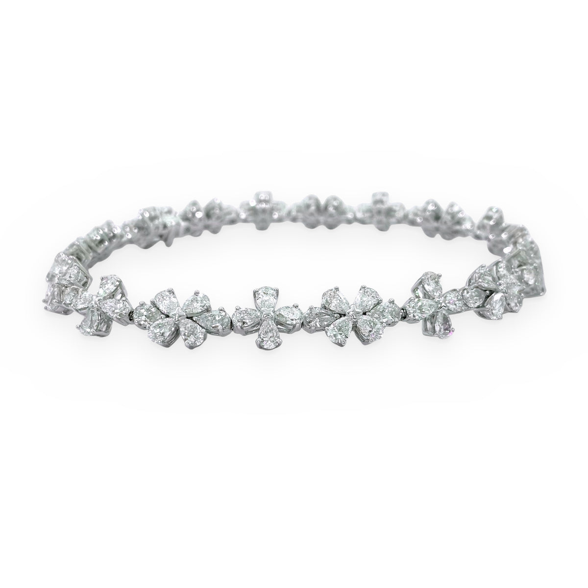 White gold diamond floral cluster bracelet with pear and round diamonds