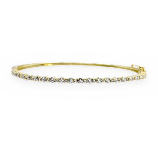 Yellow gold flexible diamond bangle with prong-set round diamonds