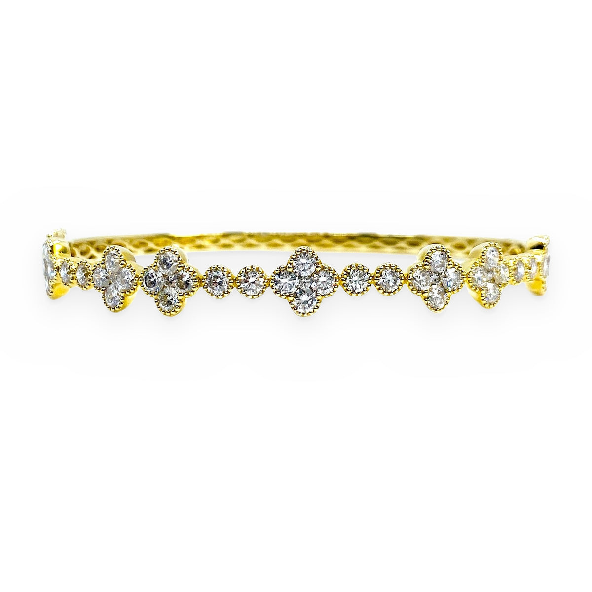 Yellow gold diamond bangle with quatrefoil clover clusters of round diamonds
