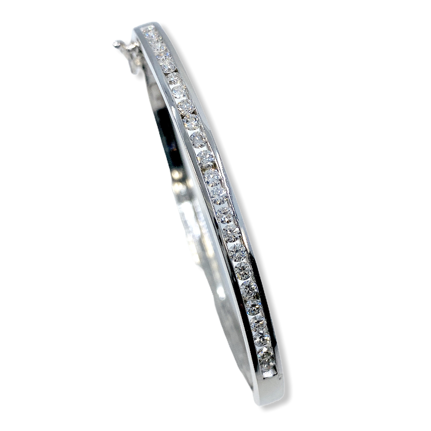 White gold channel-set diamond bangle shown vertically at an angle