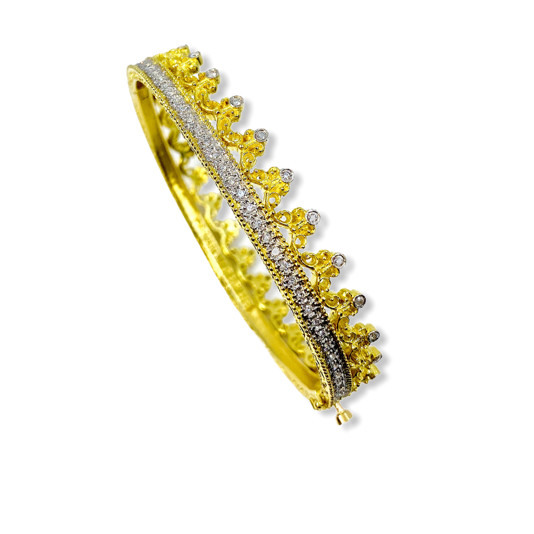 Two-tone gold crown diamond bangle shown at an angle with clasp open
