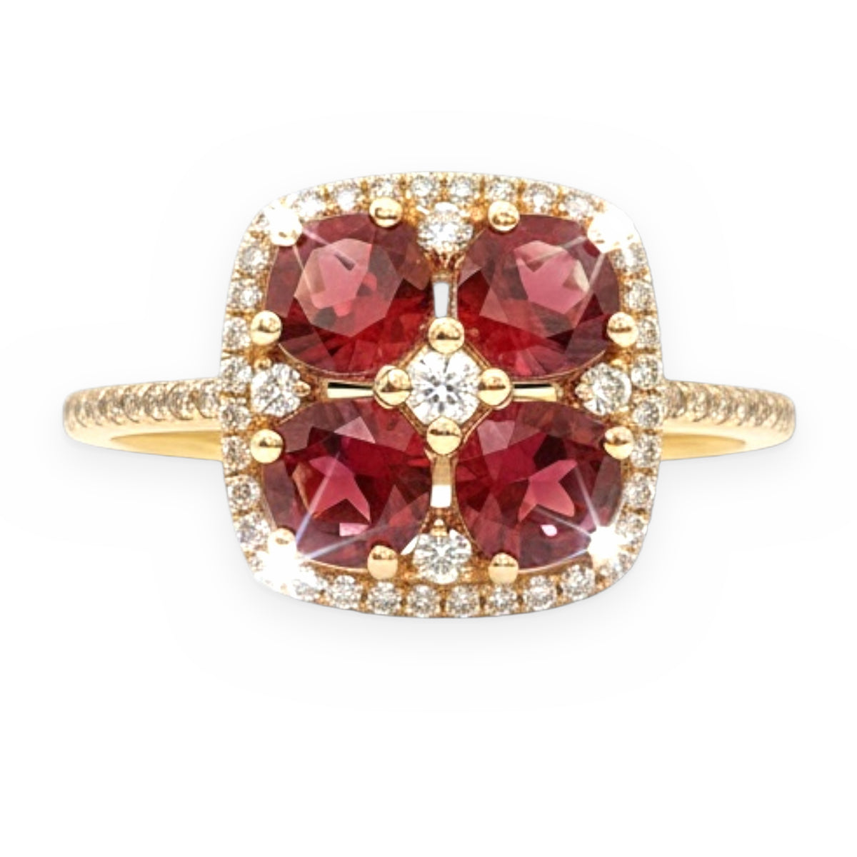 Yellow gold ring with four pinkish-red tourmaline stones and a diamond halo