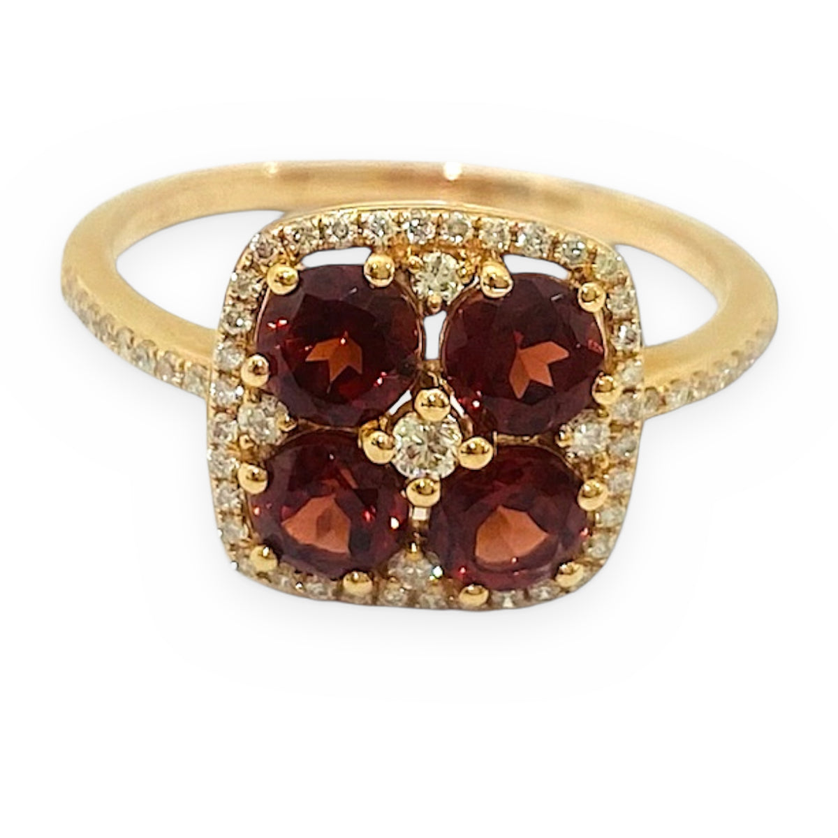 Yellow gold ring with a four-stone garnet cluster and diamond halo