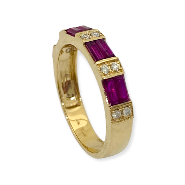 Yellow gold baguette ruby and diamond band shown at an angle