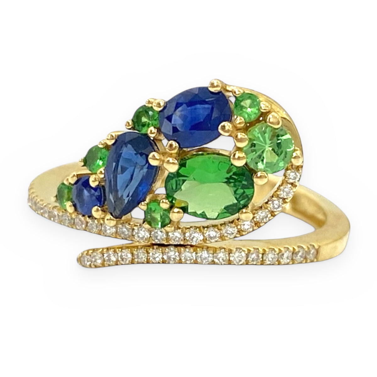 Yellow gold bypass ring with blue sapphires, green tsavorites and diamonds