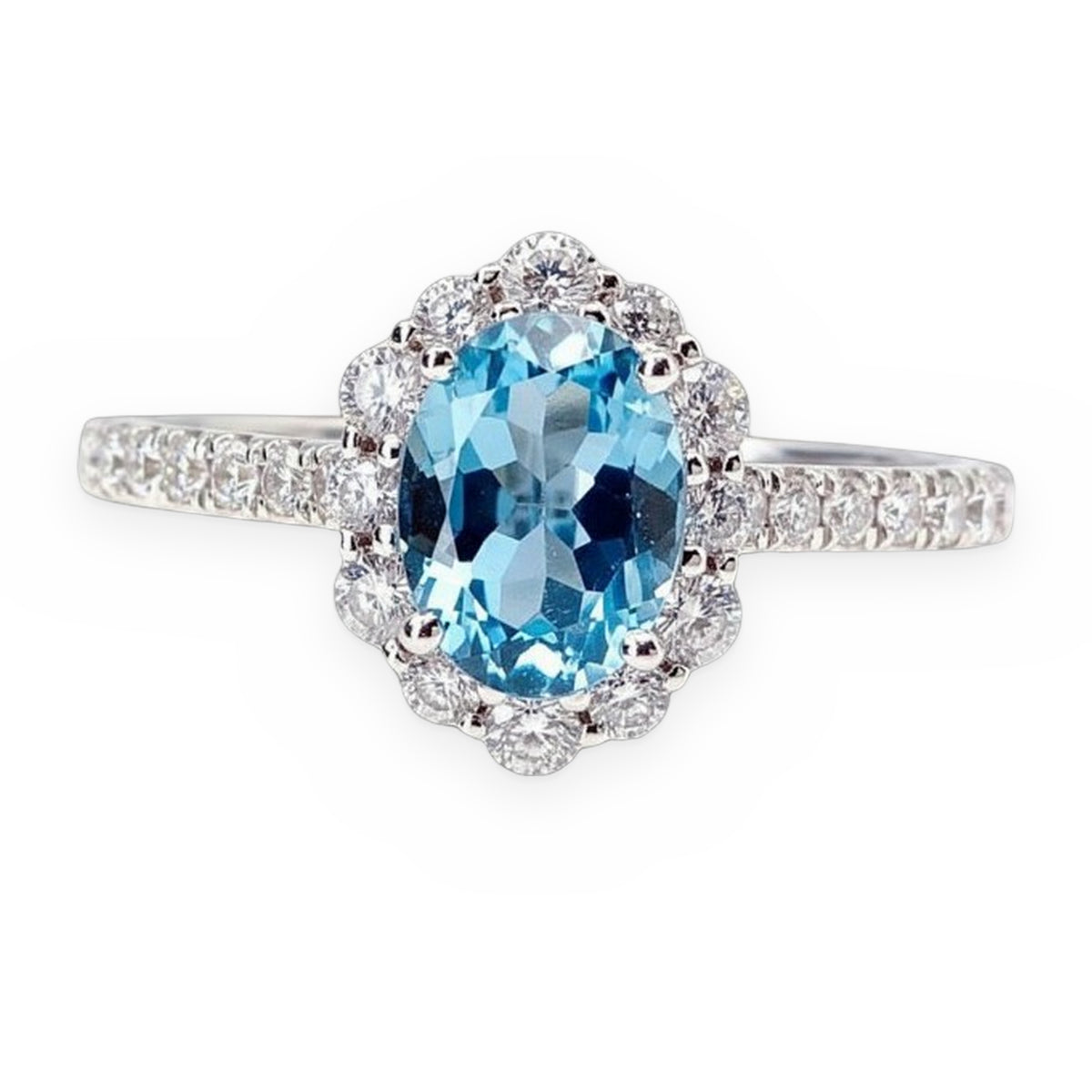 White gold ring with an oval blue topaz in a floral diamond halo