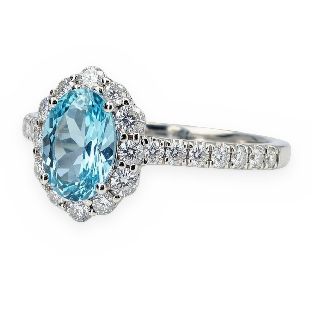 White gold oval blue topaz halo ring shown at a three-quarter angle
