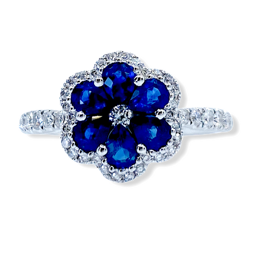 White gold flower ring with pear-shaped blue sapphire petals and a diamond halo