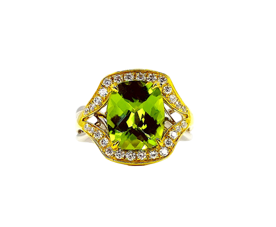 Two-tone gold cushion peridot ring with diamond halo