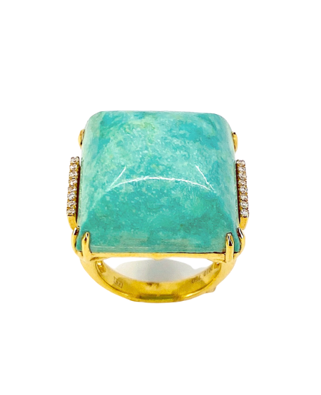 Yellow gold turquoise cabochon ring, angled view showing engraved shank
