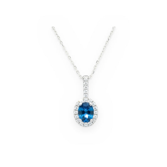 White gold oval blue topaz and diamond halo pendant on a cable chain