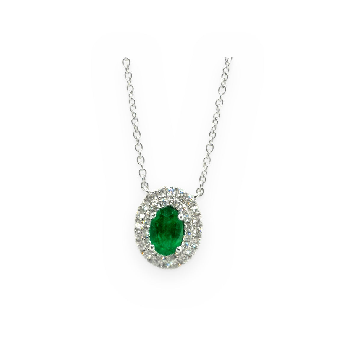 White gold oval emerald pendant with a double diamond halo on a cable chain