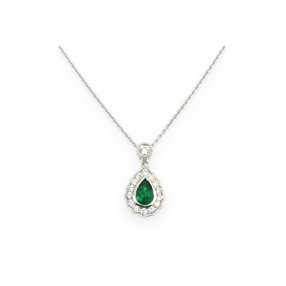 White gold pear-shaped emerald drop pendant with a milgrain diamond halo and bezel-set diamond