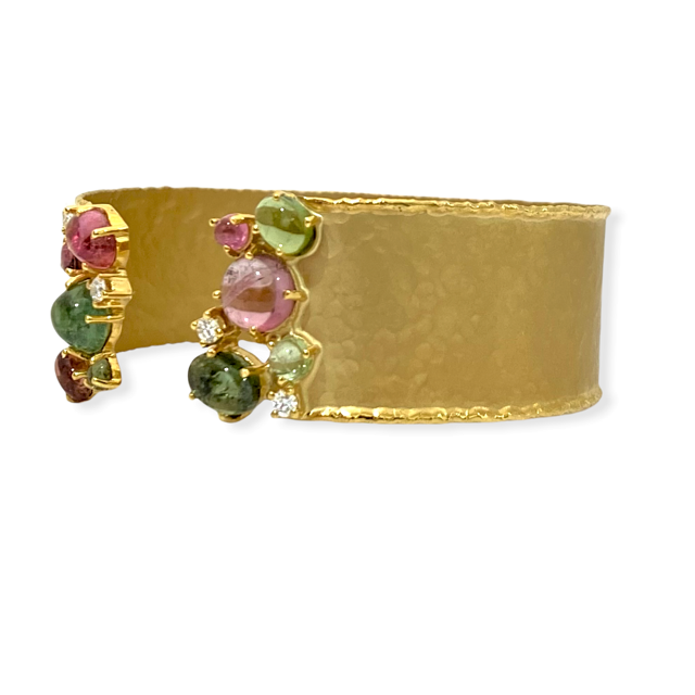 Yellow gold hammered cuff bracelet with a cluster of pink and green tourmaline cabochons and diamonds