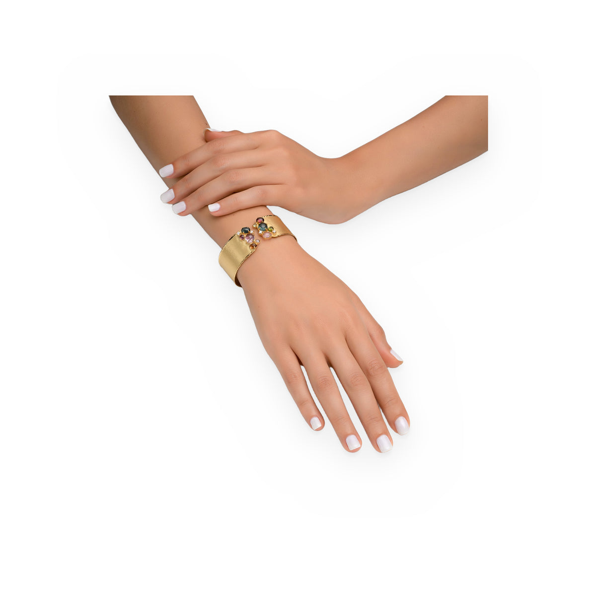 Yellow gold hammered tourmaline cuff bracelet worn on a model's wrist