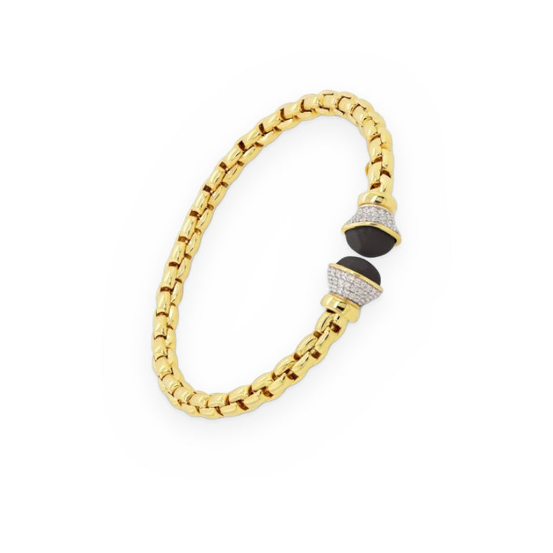 Yellow gold flexible box-link bracelet with a pave diamond and black onyx bead clasp station