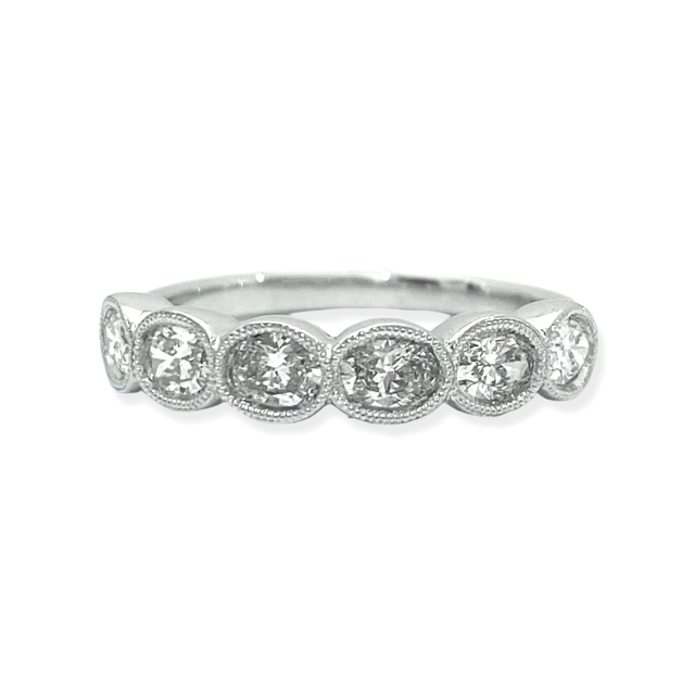 White gold oval diamond half-eternity band with milgrain bezels
