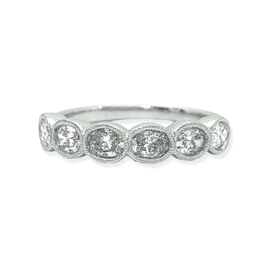 White gold oval diamond half-eternity band with milgrain bezels