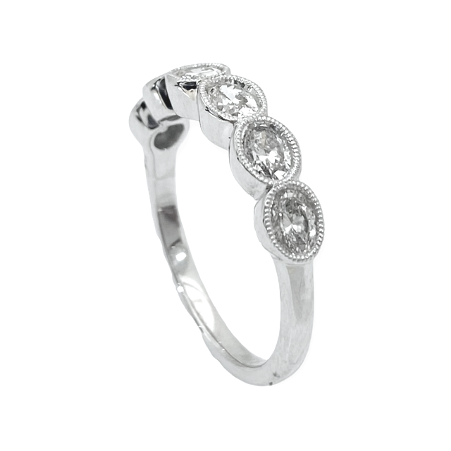Side view of a white gold oval diamond milgrain band