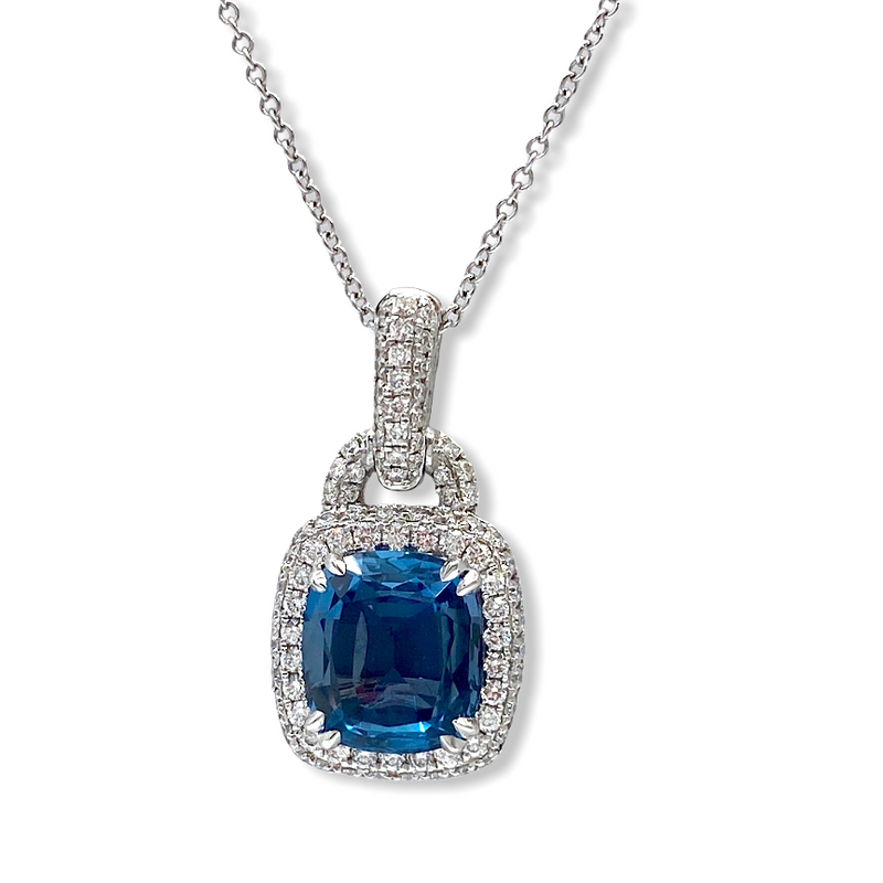 White gold cushion blue topaz pendant with diamond halo on a chain