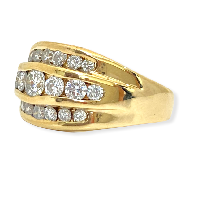Yellow gold wide diamond band shown at an angle