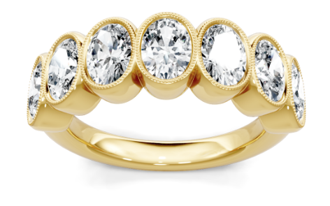Yellow gold seven-stone oval diamond bezel band with milgrain