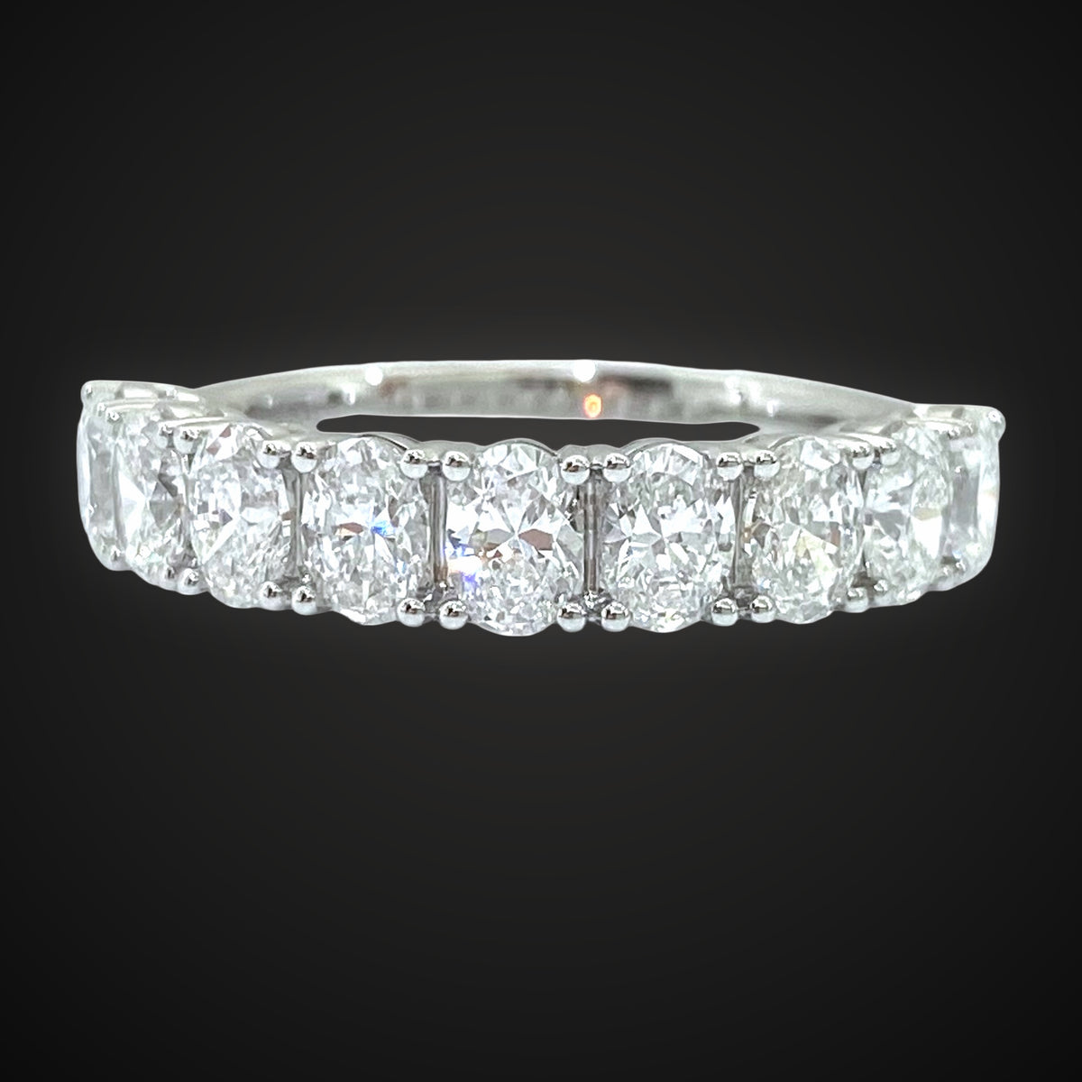 Oval diamond band in white gold on charcoal