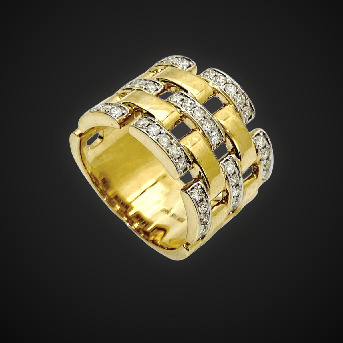 Woven yellow gold and diamond statement ring on charcoal