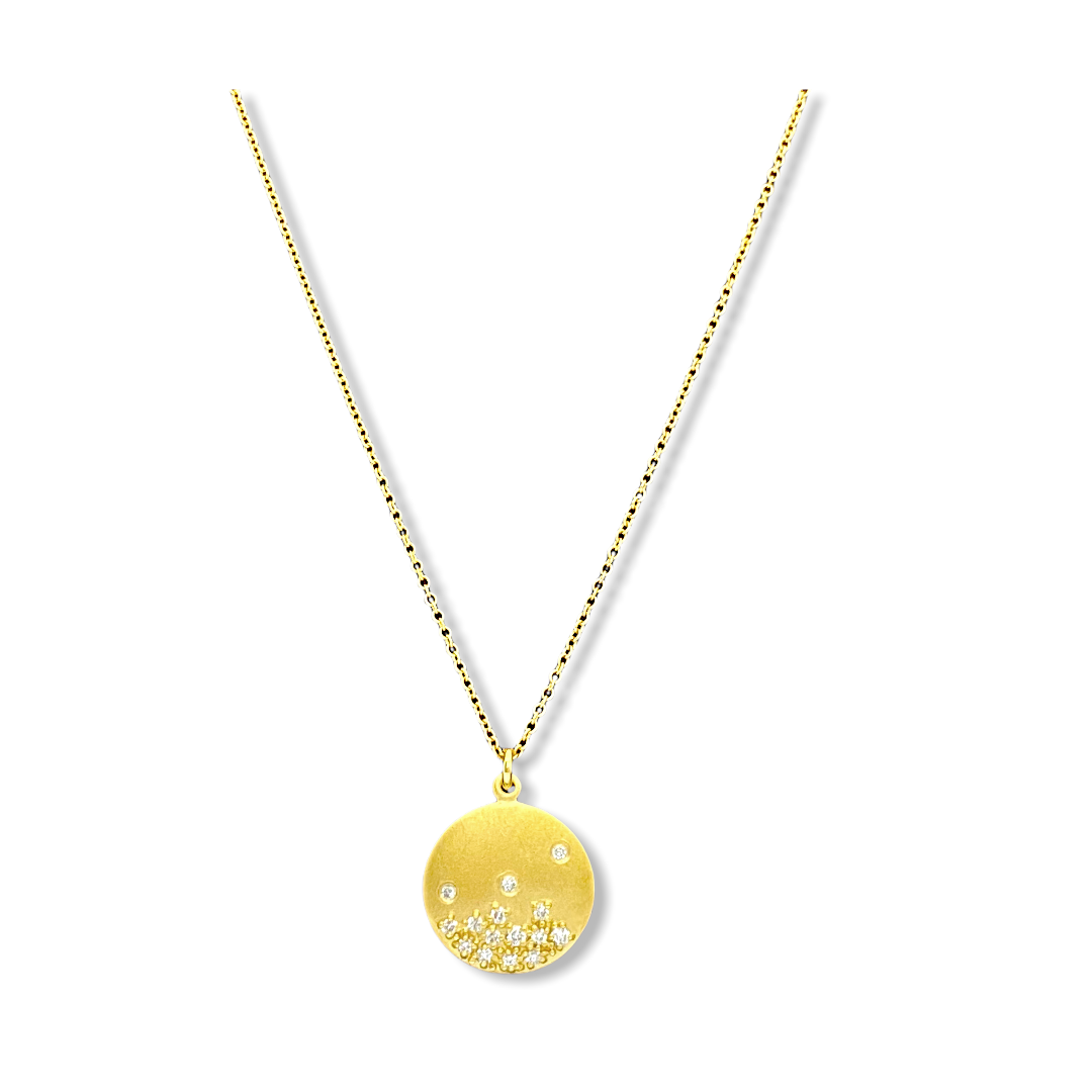 Yellow gold round disc pendant with scattered diamonds on a fine gold chain