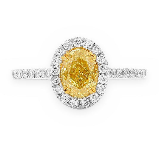 Two-tone gold ring with oval fancy yellow diamond in white diamond halo